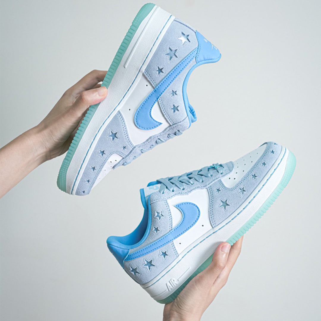 Nike Air Force 1 “Starstruck Ice Blue” — in-hand pair showing suede upper and Swoosh